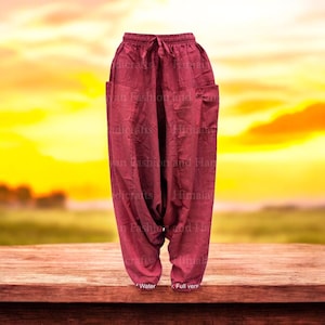 May include: A pair of loose-fitting, burgundy-colored pants with a drawstring waist and side pockets. The pants are made of a soft, comfortable fabric and have a relaxed, flowy fit.