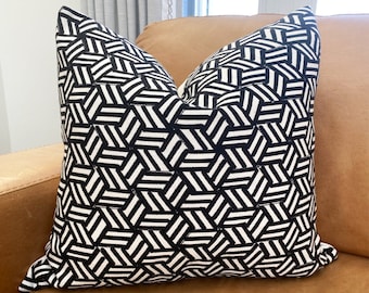 May include: A square throw pillow featuring a high-contrast black and white geometric pattern. The design consists of repeating hexagonal shapes filled with parallel diagonal lines, creating a structured, interlocking visual texture across the surface.