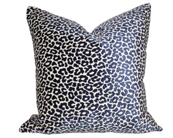 May include: A navy blue and cream pillow with a leopard print pattern.