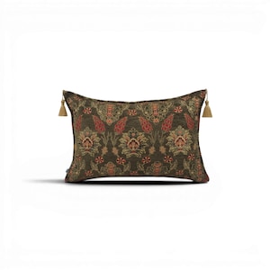 May include: A rectangular cushion with a dark olive green backdrop and a detailed floral pattern in red, orange, and gold. The cushion has gold tassels on each end. The cushion is approximately 50 cm long.