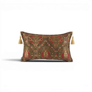 May include: Rectangular decorative pillow with a detailed floral pattern in shades of olive green, red, and gold. The pillow has a gold tassel on each end. The pillow is designed for home decor.