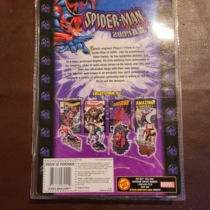 May include: A red and black Spider-Man 2099 action figure with a red and black comic book cover background. The figure is posed with its arms outstretched and its legs bent. The figure is holding a web shooter in its right hand. The comic book cover features a red and black Spider-Man 2099 character with a red and black background. The comic book cover also features the text "Amazing! Fantasy Spider-Man".