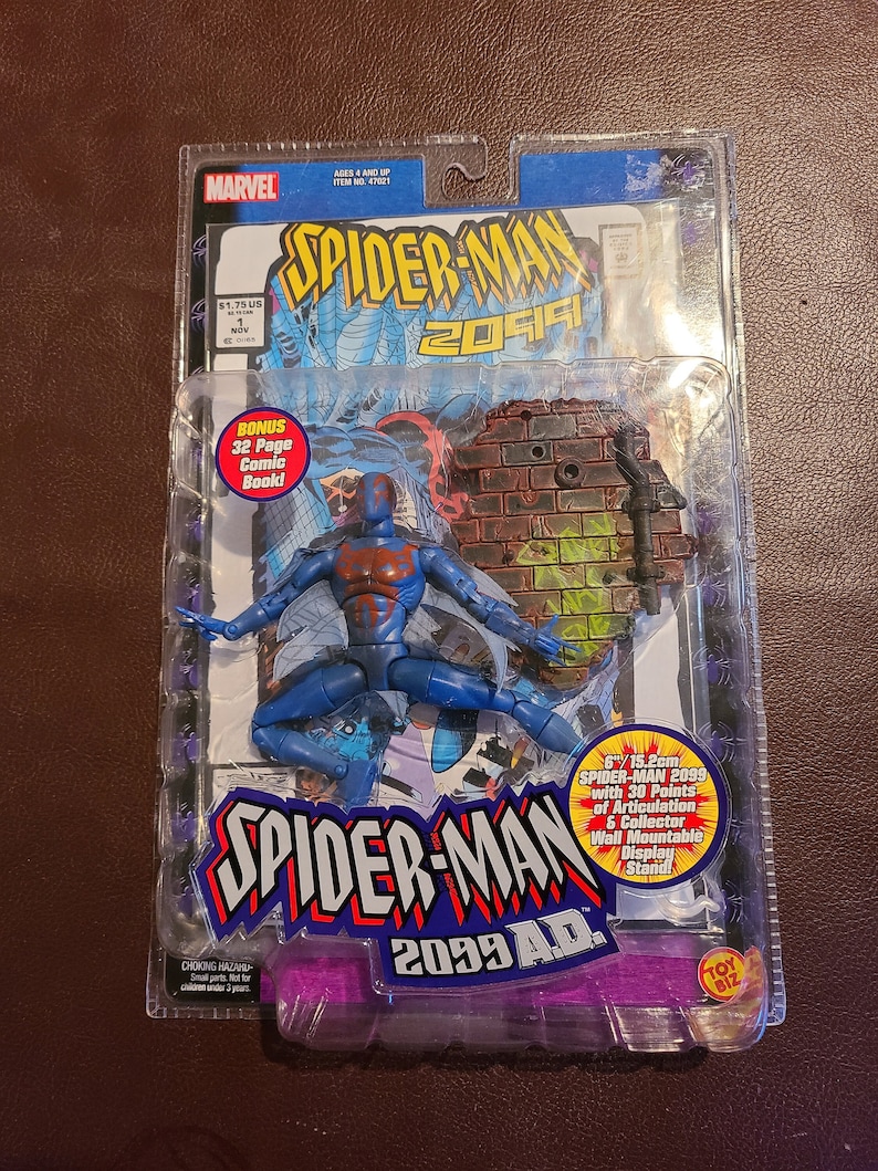 May include: A blue and red Spider-Man 2099 action figure with 30 points of articulation. The figure is packaged in a plastic blister pack with a comic book and a wall mountable display stand. The packaging features the Marvel logo and the text "Spider-Man 2099 A.D."