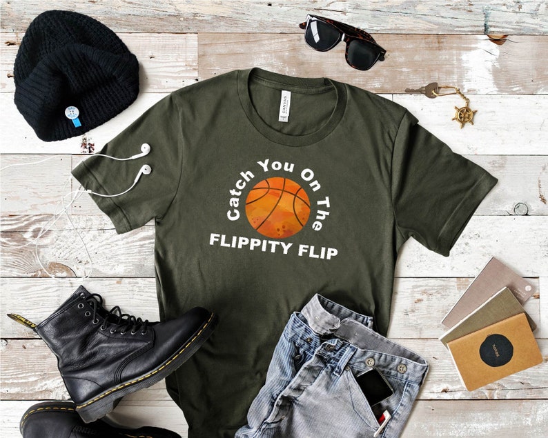 May include: A green t-shirt with the text "Catch You On The Flippity Flip" and a basketball graphic.