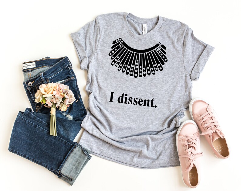 May include: A gray t-shirt with a black silhouette of a collar and the text "I dissent."