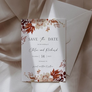 May include: Save the date card with fall foliage and floral accents. The card reads "Save the Date" for the wedding of Chloe and Richard, October 14, 2023, Richmond, VA. Formal invitation to follow.