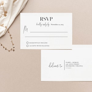 May include: A white RSVP card with black text. The text reads "RSVP kindly reply by November 10, 2025". There are two checkboxes with the text "Regretfully Decline" and "Accepts with Pleasure". A white envelope with black text reads "deliver to ISABEL ROMAN 108 LOVE STREET RICHMOND, VIRGINIA 12345".