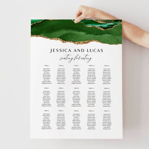 May include: A green and gold wedding seating chart with the names Jessica and Lucas and the text "seating for eating". The chart is divided into 15 tables with guest names listed under each table number.