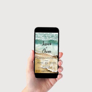 May include: A digital wedding invitation with a beach theme. The invitation features a watercolor background with a sandy beach, ocean waves, and string lights. The text reads "Jessica + Oscar" and includes the date, time, and location of the wedding.