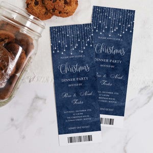 May include: Two blue and white Christmas party invitations with a string of lights design. The text reads "Please join us for a Christmas Dinner Party hosted by Rose & Noah Foster" and includes the date, time, and location of the party. The invitations also have a ticket-style design with the words "Admit One Guest" printed on them.