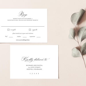 May include: A white RSVP card with black text. The text reads "RSVP" in cursive, "Kindly reply by November 1st, either by mail or on our wedding website."  The card also includes a checkbox for "accepts" and "regrets" with a space to initial next to your entree selection: beef, chicken, or vegetarian. The website address is "www.yourweddingwebsite.com".  The card also includes a white envelope with black text that reads "Kindly deliver to Richard and Olivia, 104 Love Street, Denver, Colorado 12345".