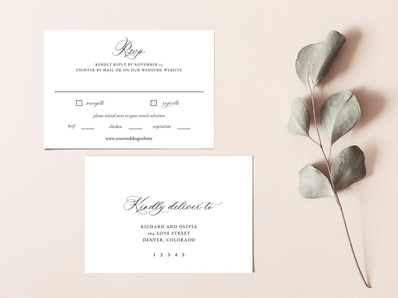 May include: A white RSVP card with black text. The text reads "RSVP" in cursive, "Kindly reply by November 1st, either by mail or on our wedding website."  The card also includes a checkbox for "accepts" and "regrets" with a space to initial next to your entree selection: beef, chicken, or vegetarian. The website address is "www.yourweddingwebsite.com".  The card also includes a white envelope with black text that reads "Kindly deliver to Richard and Olivia, 104 Love Street, Denver, Colorado 12345".