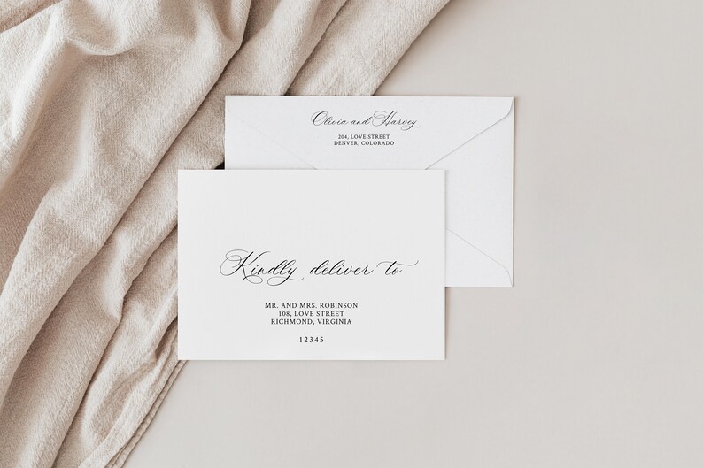 May include: A white envelope with a black handwritten inscription that reads "Kindly deliver to" followed by a name and address. The envelope is on a beige surface.