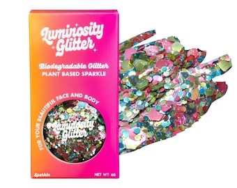 May include: A box of "Luminosity Glitter" in a gradient of orange and pink, with text that reads "Biodegradable Glitter, Plant Based Sparkle, For Your Beautiful Face and Body." The box contains a circular container of colorful glitter, with a sample of the glitter next to it.