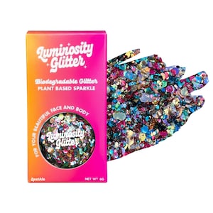 May include: A box of Luminosity Glitter in a vibrant pink and orange gradient. The box features text that reads "Biodegradable Glitter" and "Plant Based Sparkle." A circular container of glitter is visible, with a colorful mix of iridescent sparkles. A swatch of loose glitter is next to the box.