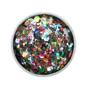 May include: A round container filled with colorful glitter. The glitter pieces are various shapes and sizes, including hexagons and irregular forms. The colors include red, green, blue, gold, and purple, creating a vibrant, multi-colored effect.