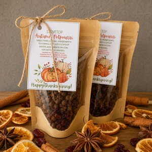 May include: Two kraft paper pouches filled with stovetop autumn potpourri, each featuring a white tag tied with twine. The tags display the text Stovetop Autumn Potpourri, directions, and Happy Thanksgiving, decorated with illustrations of pumpkins and leaves.