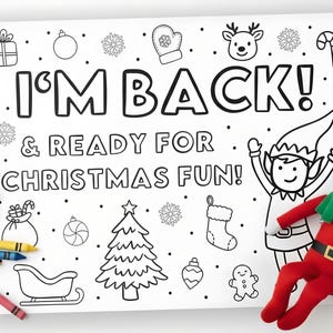 May include: A black and white coloring page with the text "I'M BACK! & READY FOR CHRISTMAS FUN!" and Christmas-themed illustrations. A red and white elf doll is positioned to the right of the page, with colorful crayons scattered on the left.