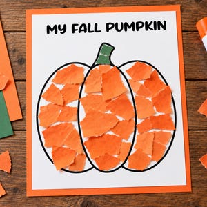 May include: A white paper sheet with the black text MY FALL PUMPKIN at the top, featuring a pumpkin outline filled with torn orange paper pieces and a green stem, accompanied by a glue stick and loose orange and green paper scraps.