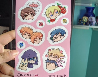 May include: A pink sheet of paper with cartoon character stickers. The stickers feature characters from the anime Ouran High School Host Club. The text "OURAN" and "@waifu.arts" are printed on the sheet.