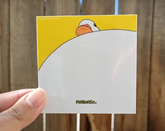 May include: Square sticker with a cartoon duck peeking over a white surface against a yellow background. The word "Pathetic." is printed in a small font at the bottom. The sticker is held by a hand.