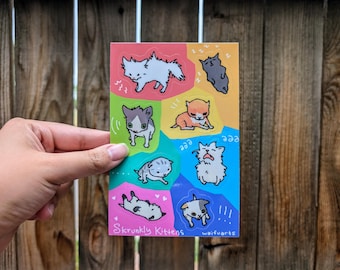 Op de afbeelding: Een vel met kleurrijke stickers met verschillende cartoon kittens in verschillende poses. De stickers zijn gelabeld met "Skrunkly Kittens" en "waifuwrbs".