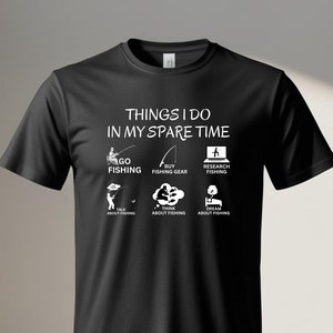 May include: Black t-shirt with white text that reads "Things I do in my spare time". The text is surrounded by six icons depicting different activities related to fishing.