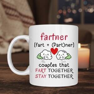 May include: White ceramic mug with the word "fartner" in red script. Below, the text reads "(fart + (Part)ner)" and "couples that FART TOGETHER STAY TOGETHER". The mug features cartoon clouds, a heart, and small hearts.