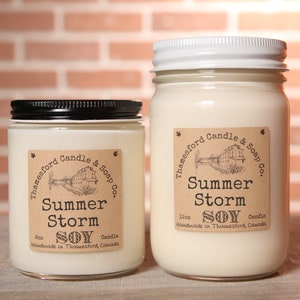 Summer Storm Scented Candle - Captures the mystery of a storm. Bergamot, green leaves, and lemon, muguet, amber, and tonka
