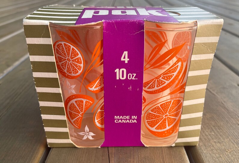 May include: A package of four 10-ounce orange juice glasses with an orange slice design. The glasses are made in Canada.
