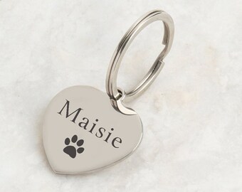 May include: Silver heart-shaped keychain with a paw print and the name "Maisie" engraved on it.