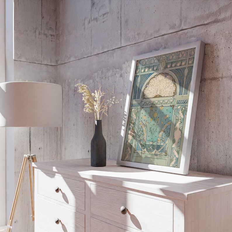 May include: A framed art print featuring an intricate illustration of a peacock with a fanned tail, rendered in shades of teal, blue, and cream. The artwork displays architectural archways and decorative floral motifs within a white rectangular frame.