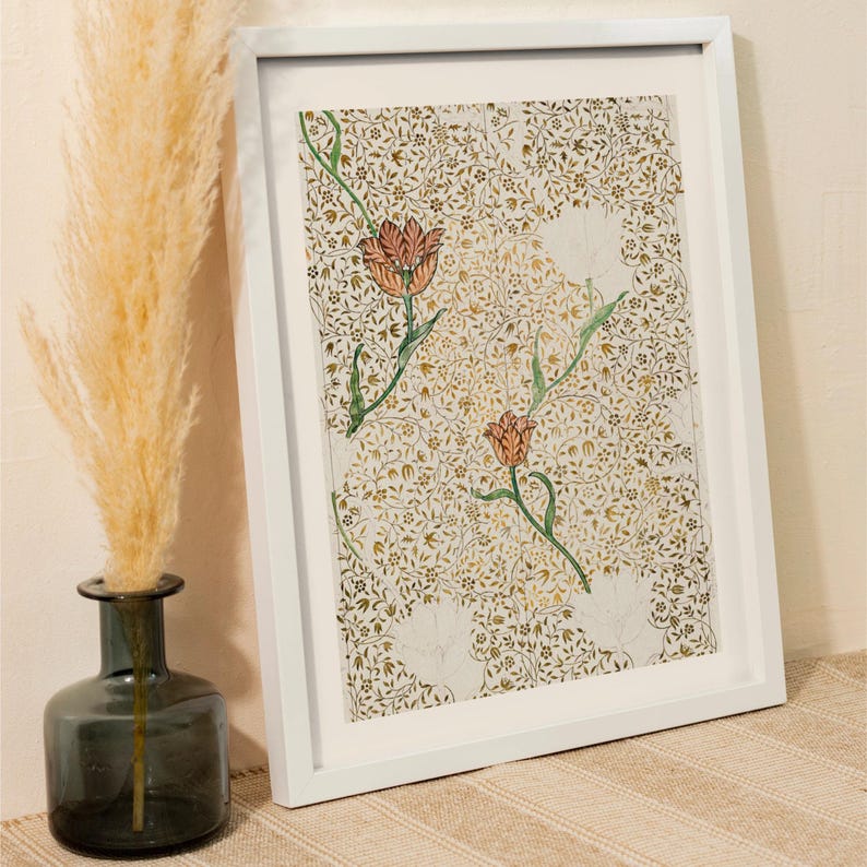 May include: A framed print featuring a dense, intricate pattern of gold and brown foliage and vines on a light background, accented by two prominent orange tulips with green stems and leaves, enclosed in a simple white rectangular frame.