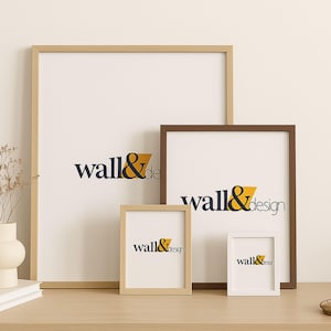 May include: Four rectangular picture frames of varying sizes and colors, including light wood, medium brown, and white finishes. Each frame contains a white insert featuring the dark blue and yellow text wall&design centered on the surface.