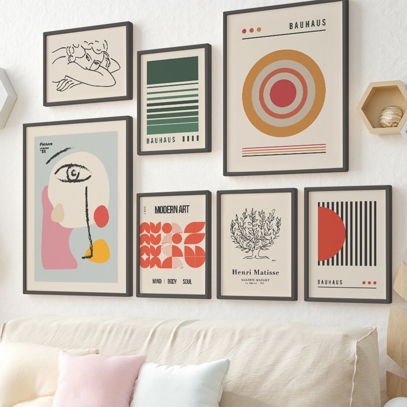 May include: A gallery wall set of seven framed art prints featuring various designs including a line drawing, Bauhaus geometric patterns, a Picasso-style abstract face, a Matisse-style tree, and typography reading Bauhaus and Modern Art.