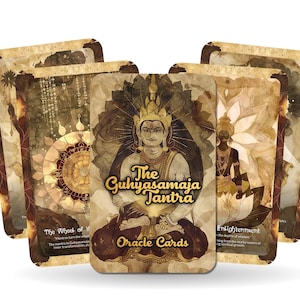 May include: A set of oracle cards with a gold and brown design. The cards feature a deity with a crown and a golden halo. The text on the cards reads "The Guhyasamaja Tantra Oracle Cards".