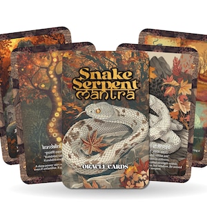 May include: A deck of Snake Serpent Mantra Oracle Cards. The cards feature illustrations of a snake coiled around a maple leaf, with text that reads "Snake Serpent Mantra" and "Oracle Cards". The cards have a warm, autumnal color palette.