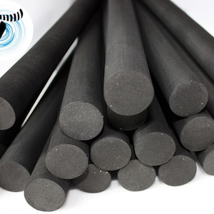 May include: A pile of black foam pipe insulation rods. The rods are approximately 2.5 cm in diameter and are stacked in a random pattern.