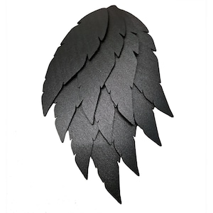May include: Black paper feather-shaped wall decor with a layered design.