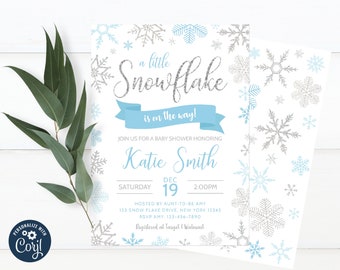 May include: A baby shower invitation with a blue and silver snowflake design. The invitation says "A little snowflake is on the way!" and includes the name "Katie Smith", the date "December 19th", and the time "2:00 PM".