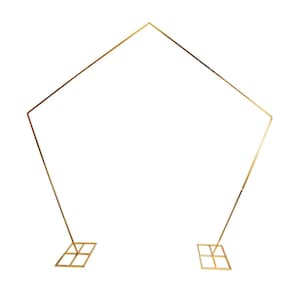 May include: A gold metal geometric arch with a pentagon shape at the top. The arch has two vertical legs with square bases. The arch is designed for weddings, parties, or other special events.