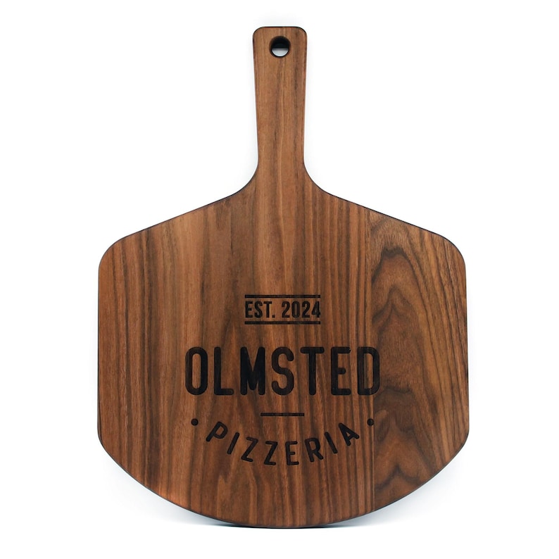 A wooden pizza board with the text "OLMSTED PIZZERIA" engraved on it.