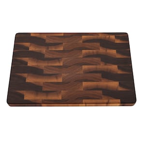 a rectangular wooden cutting board with a dark brown, textured surface.