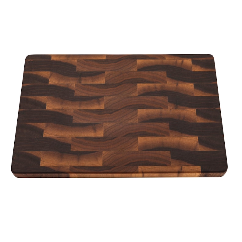 a rectangular wooden cutting board with a dark brown, textured surface.