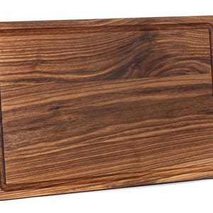 A wooden cutting board with a natural wood grain texture and visible grain lines.