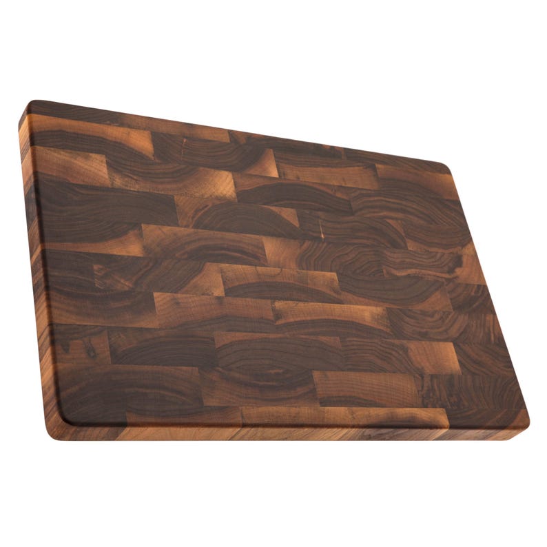 A wooden cutting board with a dark brown, natural wood grain pattern.