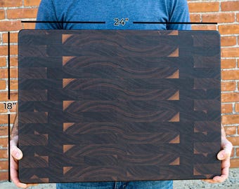 May include: A rectangular end-grain cutting board featuring a dark brown wood pattern with visible grain lines. The board measures 24 inches in width and 18 inches in height, as indicated by the text labels on the image surface.