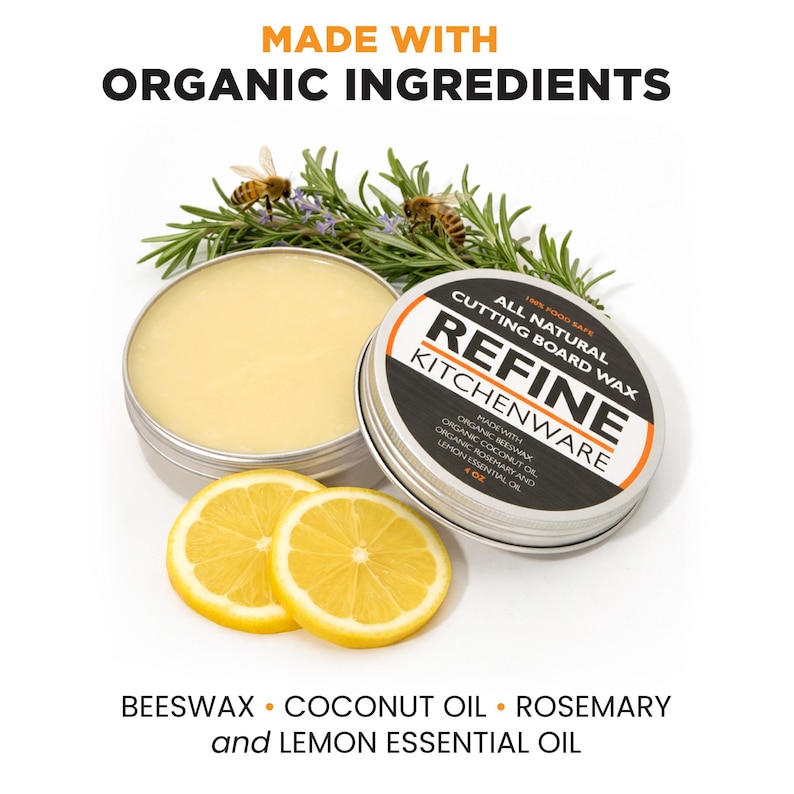 May include: Image of two open metal tins of cutting board wax, with rosemary and lemon slices. The text on the tin reads "Refine Kitchenware" and "Made with Organic Ingredients". The ingredients are listed as beeswax, coconut oil, rosemary, and lemon essential oil.