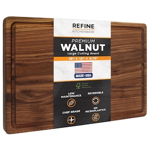 May include: A rectangular premium walnut cutting board with a juice groove. The board is 18" x 12" x 0.75" and features the text "PREMIUM WALNUT" and "MADE IN USA". It is reversible, chef grade, and low maintenance.