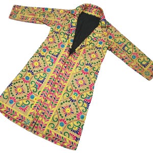 May include: A long, embroidered coat with a floral pattern in shades of yellow, pink, blue, and green. The coat has a black lining and a button closure.